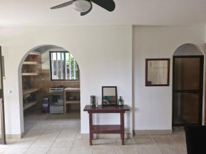 a kitchen with a table and a ceiling fan at El Diamante - Playa Hermosa in Playa Hermosa
