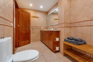 a bathroom with a toilet and towels on a shelf at Habitación en el centro con Baño in Santa Cruz de Tenerife