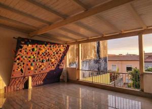 a balcony with a large rock wall at Da Marilena in Sorso