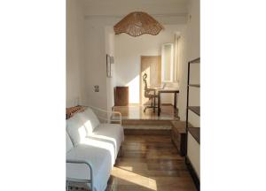 a living room with a white couch and a table at Da Marilena in Sorso +66 photos