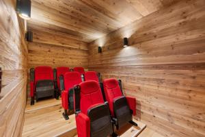 a group of red chairs in a room with wooden walls at Chalet Dents Blanches - Latitude Champéry in Champéry
