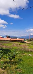 a field of grass with a building in the background at Mirador del Molino in Fusagasuga