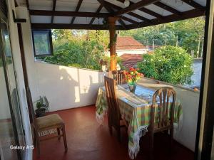 a porch with a table and chairs on a balcony at Kumari villa in Weligama