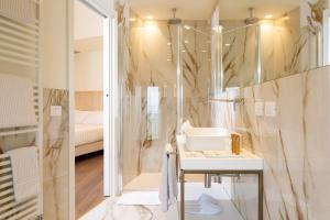 a bathroom with a sink and a mirror at Giotto Hotel & Spa in Assisi +84 photos