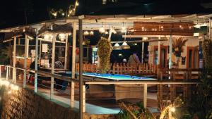 a restaurant with a pool in front of it at night at Lưng Chừng House in Da Lat