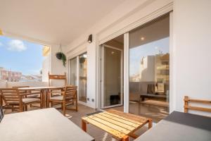 a room with a table and chairs and a balcony at GuestReady-Charming Coastal Getaway in Almada +29 photos