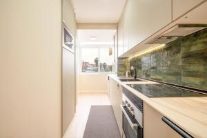 a kitchen with a sink and a counter at GuestReady-Charming Coastal Getaway in Almada