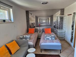 a room with two beds and a couch at Studio équipé Brussels in Sint-Pieters-Leeuw