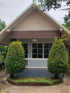 a house with two bushes in front of it at Rawinnipha's Resort & Garden Khonkaen in Khon Kaen +17 photos