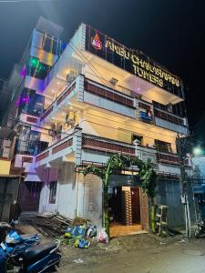 a building with a sign on the side of it at Hotel Anbu Airport in Chennai