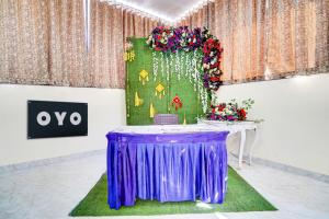 una mesa en una habitación con un mantel púrpura en Hotel O Godavari Lawn, en Jabalpur