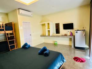 a room with a bed and a tv and a refrigerator at Kohyao Non Bay in Ko Yao Yai