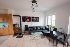 a living room with a couch and a table at Beskid Penthouse Milówka in Milówka