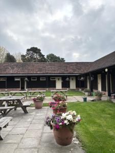a building with benches and flowers in front of it at The Farmyard at Doddington in Doddington