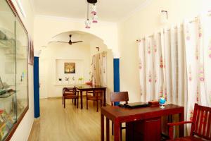 a living room with a table and a dining room at Casa maryam in Fort Kochi +35 photos