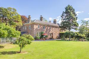 8 Bed in Invergordon oc-p32711 في Barbaraville: منزل من الطوب كبير مع ساحة خضراء