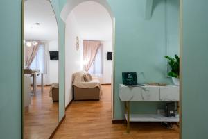a hallway with a mirror and a living room at St Mark's Square - K Collection in Venice