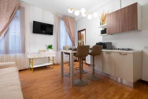 a living room with a kitchen and a table with chairs at St Mark's Square - K Collection in Venice +105 photos