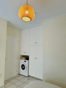 a kitchen with a washer and a washing machine at Sophilia Garden escape in Patra
