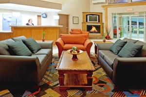 a living room with couches and a coffee table at Holiday Inn Express Murrysville - Delmont by IHG in Delmont