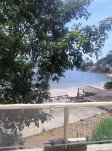 a view of a beach with a pier and the water at Jade Beach Club in São Vicente +1 photo