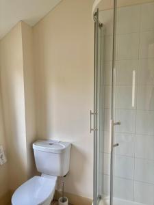 a bathroom with a toilet and a glass shower at The Farmyard at Doddington in Doddington +56 photos