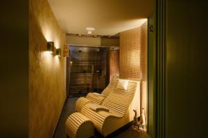 a living room with a yellow and white striped couch at Franz Apartments in Ilirska Bistrica