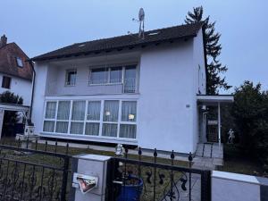 a white house with a fence in front of it at Vermietung Daniel in Nürnberg