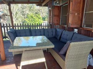 a blue couch and a table on a patio at Phulomnum Resort in Ban Thung Samo