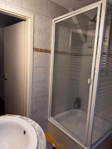 a glass shower in a bathroom with a sink at Vermietung Daniel in Nürnberg