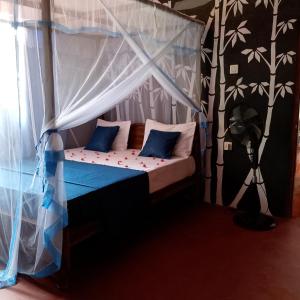 Postel nebo postele na pokoji v ubytování Talalla Mango House