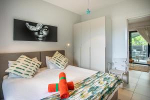 een slaapkamer met een bed met een knuffeldier erop bij Luxury Beachfront Apt - Perfect for Beach Lovers in Rivière Noire