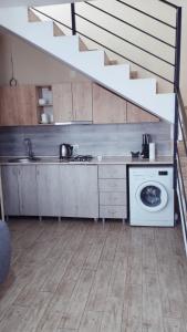 a kitchen with a sink and a washing machine at bakuriani in Bakuriani