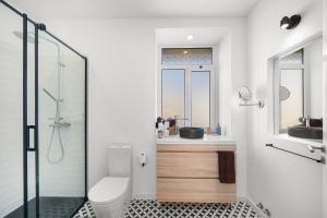 a bathroom with a toilet and a sink and a shower at Casa NOLA by Susys Holidays in Funchal +49 photos