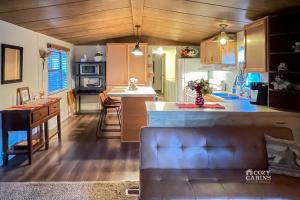 a kitchen with a couch and a counter in a room at Ruidoso Mountain Getaway Centrally Located in Ruidoso