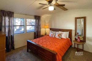 a bedroom with a bed and a ceiling fan at Ruidoso Mountain Getaway Centrally Located in Ruidoso