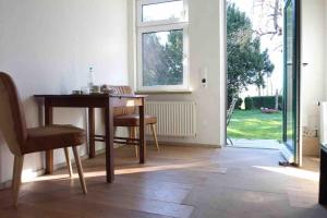 a dining room with a table and chairs and a window at Schöner alter Resthof am Jadebusen in Reitland +19 photos