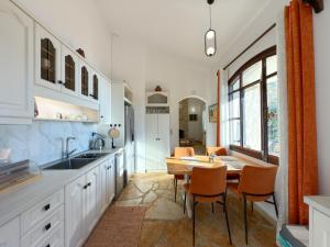 a kitchen with a table and a dining room at Villa Kalami Look Out in Kalami