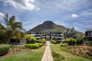 een uitzicht op een resort met een berg op de achtergrond bij Luxury Beachfront Apt - Perfect for Beach Lovers in Rivière Noire