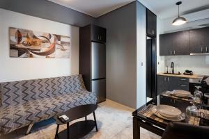 a living room with a bed and a kitchen at Agnanti Apartment in Agrinio