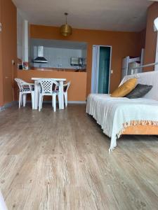 a bedroom with a bed and a table and chairs at Hostel Feminino Sol de Maria in Salvador