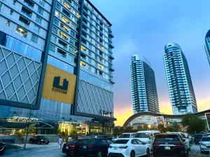 a parking lot in front of two tall buildings at Executive Apartments In The Heights of Elysium Tower - Islamabad in Islamabad