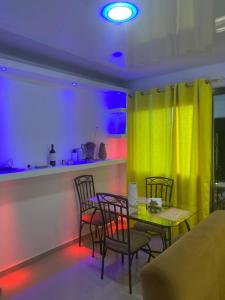 a dining room with a table and chairs and a yellow curtain at Mi Rinconcito in Colorado +2 photos