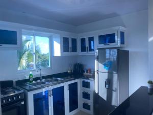 a kitchen with white cabinets and a refrigerator at Mi Rinconcito in Colorado