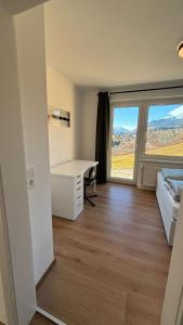 a room with a desk and a bed and a window at Ferienwohnung Amseltraum in Seeboden