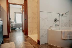 a bathroom with a shower and a bath tub at Luxury farm Stay, Alexandria in Glen Robertson +17 photos