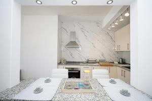 a kitchen with a table with chairs and a counter top at B50 - Main Square Apartment in Lagos in Lagos