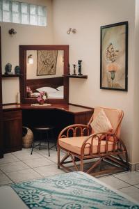 a bedroom with a desk and a chair and a mirror at Ayurveda Spring Of Life Resort in Piliyandala