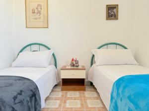two beds sitting next to each other in a room at Casa Tonia - Baia Verde in Baia Verde