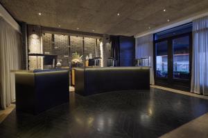 a lobby with chairs and a table in a building at Radisson Blu Hotel, London Leicester Square in London